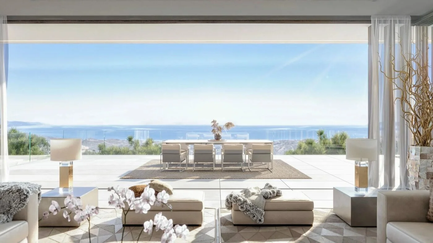 A villa terrace dining table set for eight with orchids and a panoramic sea view